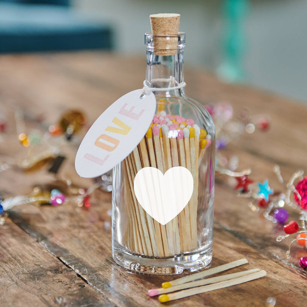 A bottle of Love Matches And Votives Gift Set