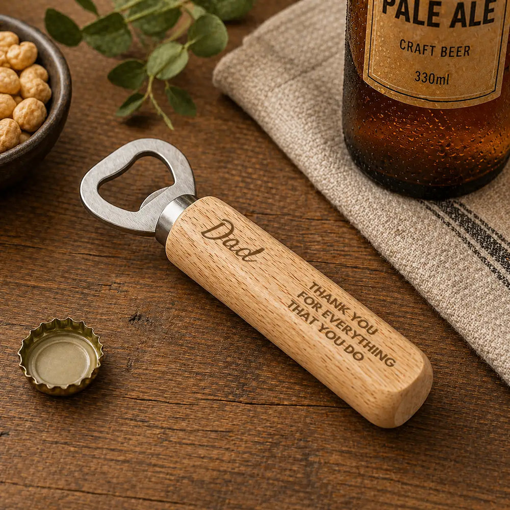 A wooden-handled bottle opener with a silver metal cap, engraved with ’dad’ and the message “thank you for everything that you do.”