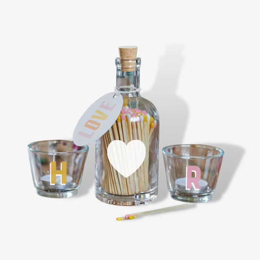 A bottle of Love Matches And Votives Gift Set